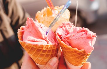 Three Colorful Tasty Ice-cream Cones In Hands. Sunny Background