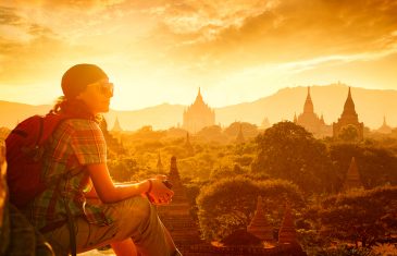 Young traveller enjoying a looking at sunset on Bagan Myanmar Asia. Traveling along Asia active lifestyle concept