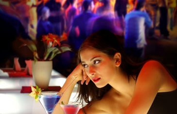 woman drinking cocktail during a party
