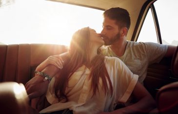 Couple On Road Trip Sharing A Romantic Kiss