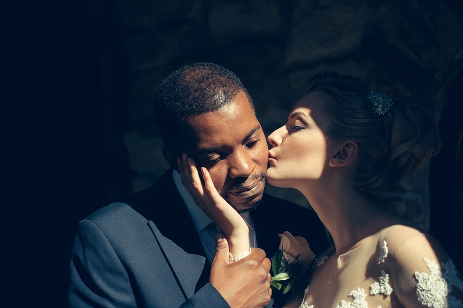 beautiful bride kissing tenderly handsome man