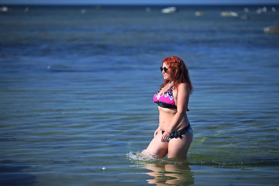 Happy Young Plus Size Woman In Bikini On Sea