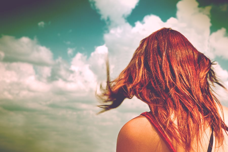 Anonymous Woman With Red Hair And Blue Sky.woman On Her Back Wit