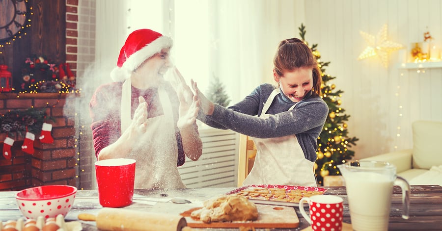 happy family married couple baking christmas cookies and laughing