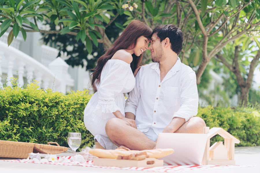 Young Couple Go Picnic At The Park In Summer.