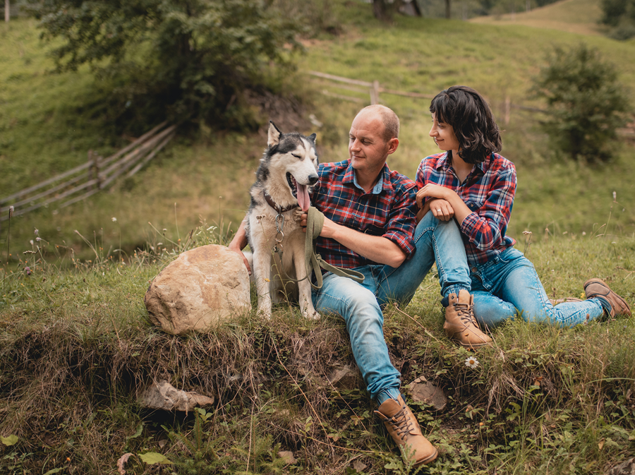 happy couple with dog in spring